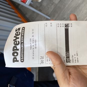 Popeyes Louisana Kitchen - a hand holding a receipt - Chicken Wings Near Me - Calgary, Alberta Popeyes Louisana Kitchen - a hand holding a receipt - Chicken Wings Near Me - Calgary, Alberta