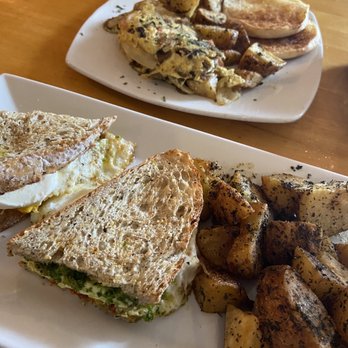 Corner Cafe - Cheeky Emma breakfast sandwich in front and Irishman omelette in background. - Breakfast & Brunch Near Me - Newport, Rhode Island Corner Cafe - Cheeky Emma breakfast sandwich in front and Irishman omelette in background. - Breakfast & Brunch Near Me - Newport, Rhode Island