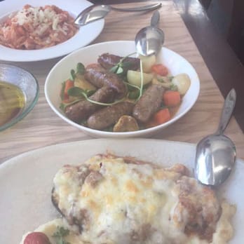 Zaytinya - Chicken dish in the back. Sausage dish in the middle. Eggplant dish in the front. - Greek Near Me - Washington, DC, District of Columbia