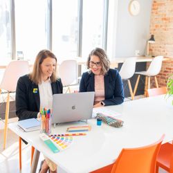 Shapes & Colors by Jolinda - Jolinda Smithson, the principal owner of Shapes & Colors, reviewing logo concepts with a client.