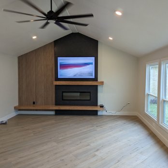 Unique Builders And Remodeling Houston - a living room with a fireplace and a flat screen tv - General Contractors Near Me - Houston, Texas Unique Builders And Remodeling Houston - a living room with a fireplace and a flat screen tv - General Contractors Near Me - Houston, Texas
