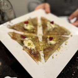 Katmer dessert - thin flaky fried pastry on the outside, pistachio and sweet filling on the inside. Dangerously delicious