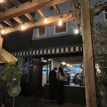 Dune - Restaurant from the outside at night- illuminated by fairy lights and warmed by a fire heater - Falafel Near Me - Los Angeles, California Dune - Restaurant from the outside at night- illuminated by fairy lights and warmed by a fire heater - Falafel Near Me - Los Angeles, California