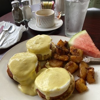Sunrise Breakfast - Traditional Eggs Benedict with home fries and a slice of watermelon. - Breakfast & Brunch Near Me - Norwood, Massachusetts Sunrise Breakfast - Traditional Eggs Benedict with home fries and a slice of watermelon. - Breakfast & Brunch Near Me - Norwood, Massachusetts