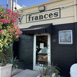 Frances - The store sign from the back parking lot