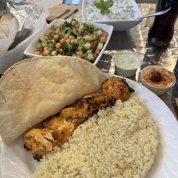 Cucumber salad, protein salad and chicken , rice and pita bread.