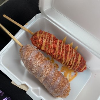 Two Hands Corn Dogs - Spicy Hot Cheetos dusted corn dog with half cheese and half sausage. Classic corn dog filled with cheese. - Hot Dogs Near Me - Houston, Texas Two Hands Corn Dogs - Spicy Hot Cheetos dusted corn dog with half cheese and half sausage. Classic corn dog filled with cheese. - Hot Dogs Near Me - Houston, Texas