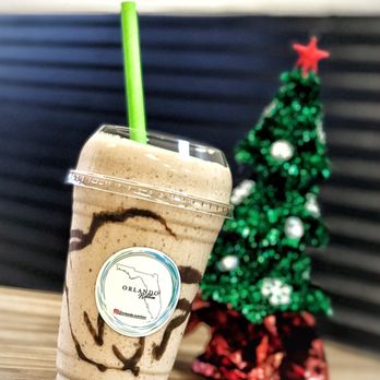 Orlando Nutrition - a cup of iced coffee with a straw and a christmas tree in the background - Juice Bars & Smoothies Near Me - Lake Mary, Florida Orlando Nutrition - a cup of iced coffee with a straw and a christmas tree in the background - Juice Bars & Smoothies Near Me - Lake Mary, Florida