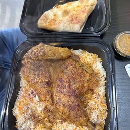 Spicy half chicken with rice. Husband says it's not very spicy. They will let you sample the sauce.