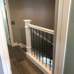 Solid pony wall replaced with iron/wood balusters.