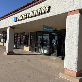 Bricks & Minifigs - Exterior view of Bricks & Minifigs store in Tempe, AZ, showing signage, glass entrance doors, and part of the building facade. - Toy Stores Near Me - Tempe, Arizona