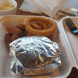 a tray of food with onion rings, onion rings, and a fork a tray of food with onion rings, onion rings, and a fork