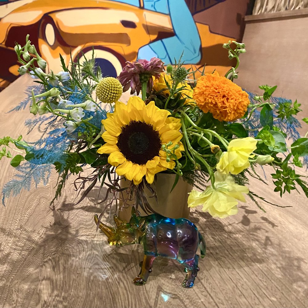 Centerpieces got a little droopy due to some unexpected rain during our event, but still stunning, bold, and unique! LOVE the blue greenery!