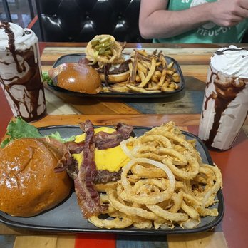 Twisted Root Burger - Top: The Western with fries Bottom: All American with onion rings Chocolate Shakes - Burgers Near Me - Waco, Texas Twisted Root Burger - Top: The Western with fries Bottom: All American with onion rings Chocolate Shakes - Burgers Near Me - Waco, Texas