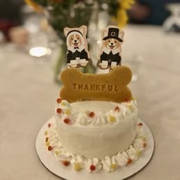 Pumpkin Thanksgiving cake, custom bone included in the $25 standard cake price (pilgrim cake toppers are mine) Pumpkin Thanksgiving cake, custom bone included in the $25 standard cake price (pilgrim cake toppers are mine)