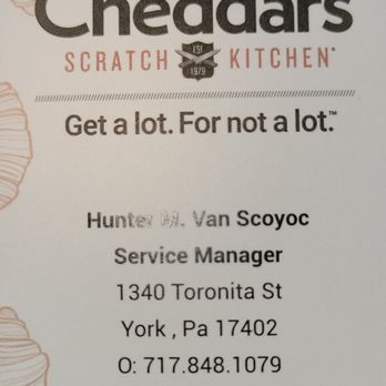Cheddar's Scratch Kitchen - Cheddar's Business Card - A business card for Cheddar's Scratch Kitchen, located in York, PA, includes the restaurant's logo, slogan 'Get a lot. For not a lot.', and contact information for Hunter M. Van Scoyoc, Service Manager. The card displays the address 1340 Toronita St, York, PA 17402, and phone number 717.848.1079, with the website Cheddars.com. The design features a white background with decorative croissant illustrations. - American Near Me - York, Pennsylvania