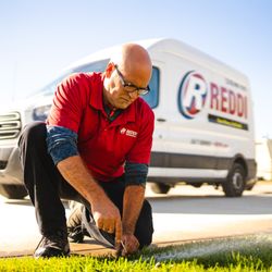 Reddi Sprinklers & Irrigation Systems - Reddi sprinkler tech adjusting a sprinkler head in Wichita, KS.