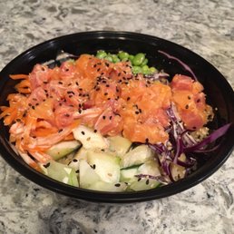 Poke bowl with spicy salmon, spicy tuna, cucumber, carrots, purple cabbage, edamame, sesame, yum yum sauce, and poke sauce. Poke bowl with spicy salmon, spicy tuna, cucumber, carrots, purple cabbage, edamame, sesame, yum yum sauce, and poke sauce.