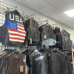 Hasbro Leather - An Array of Motorcycle Vests displayed on wall. We carry 100+ styles of leather vests. and all inclusive sizes.