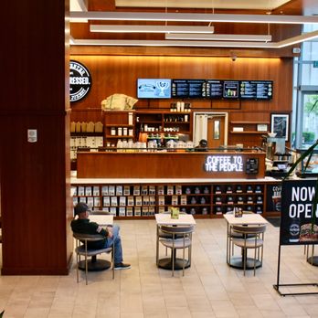 Town Center Cold Pressed - a man sitting at a table - Coffee & Tea Near Me - Norfolk, Virginia Town Center Cold Pressed - a man sitting at a table - Coffee & Tea Near Me - Norfolk, Virginia