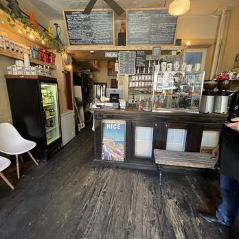 Cafe Panino Mucho Giusto - a man standing in front of the counter - Bagels Near Me - New York, New York Cafe Panino Mucho Giusto - a man standing in front of the counter - Bagels Near Me - New York, New York