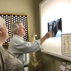 Family Chiropractic Center - Dr. Margolies explaining cervical X-rays to a patient, he has an in house X-ray facility.