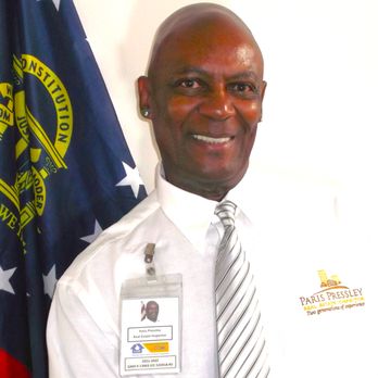 Hawkeye Home Inspection - Paris Pressley in his Atlanta office with State of Georgia flag behind him - Home Inspectors Near Me Hawkeye Home Inspection - Paris Pressley in his Atlanta office with State of Georgia flag behind him - Home Inspectors Near Me