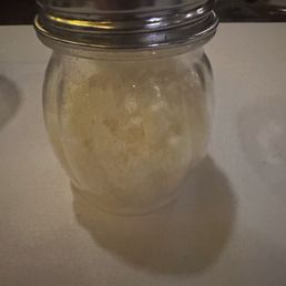 The shaker of grated cheese