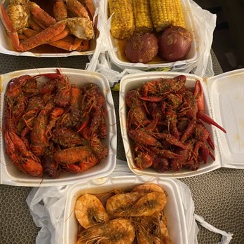 Crawfish King - a variety of food in containers - Laotian Near Me - Live Oak , Texas