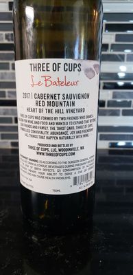 Photo of Three of Cups - Woodinville, WA, US. a bottle of cabernet sauvignon