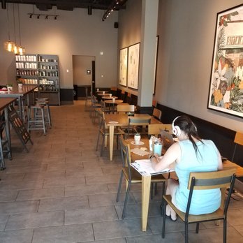 Starbucks - a woman sitting at a table in a coffee shop - Coffee & Tea Near Me - Myrtle Beach, South Carolina Starbucks - a woman sitting at a table in a coffee shop - Coffee & Tea Near Me - Myrtle Beach, South Carolina
