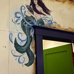 Pirate Haus Inn - Mermaid mural above door.