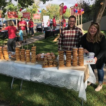 Mr. Yo's Donut - a man and woman standing behind a table of donuts - Donuts Near Me - Windsor, Colorado Mr. Yo's Donut - a man and woman standing behind a table of donuts - Donuts Near Me - Windsor, Colorado