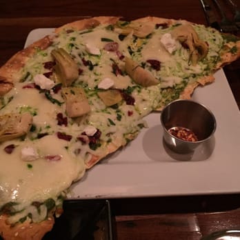 Twisted Cork Bistro - Laura's Lahvosh basil pesto, sun dried tomato, artichoke, Havarti, mozzarella, goat cheese, red pepper flakes - New American Near Me - Omaha, Nebraska