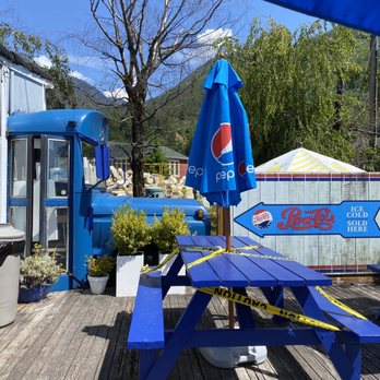 Mountain Woman - blue picnic table with blue umbrella - Burgers Near Me - Britannia Beach, British Columbia