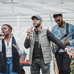 Living Word International Christian Church - Young worshippers singing at the outdoor church service.