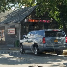 a silver suv parked in front of a restaurant a silver suv parked in front of a restaurant