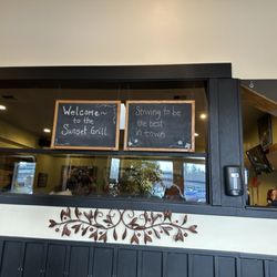 Sunset Grill - Walking in the door. There is a seating area behind the sign. We chose to be in the other area.