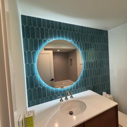 Alpine Tile & Contracting - Modern fish scale subway tile with backlit mirror and floating vanity.