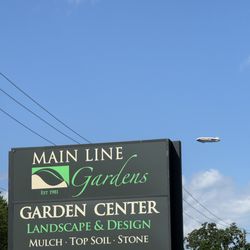 Main Line Gardens - Our Sign with the Good Year Blimp in the background