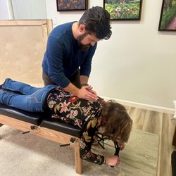 TOPO Chiropractic - Dr. John Christman performing an adjustment.