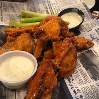 The Old Bull & Bush - a plate of chicken wings with a side of ranch dressing - British Near Me - Myrtle Beach, South Carolina
