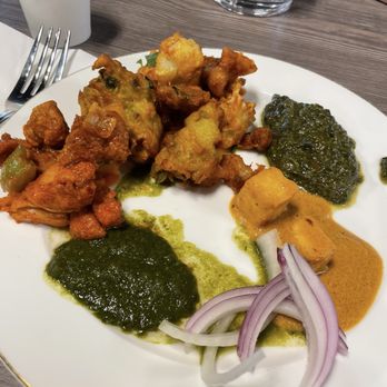 The Urban Grill - Clockwise: Chicken chilly, Spinach Pakora, Paneer Butter Masala, Saag Paneer and mint chutney. - Indian Near Me - Sunnyvale, California The Urban Grill - Clockwise: Chicken chilly, Spinach Pakora, Paneer Butter Masala, Saag Paneer and mint chutney. - Indian Near Me - Sunnyvale, California