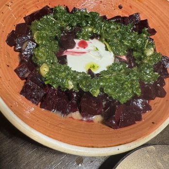 Osa Rooftop - Burrata and beets - A dish with diced beets arranged in a circular pattern, topped with a green herb sauce and a dollop of white sauce, served in a ceramic bowl. - Bars Near Me - Pasadena, California