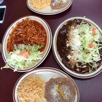 Homi Mexican - Spicy chicken on left, mole enchiladas on right. Also came with corn tortillas. - Mexican Near Me - Saint Paul, Minnesota Homi Mexican - Spicy chicken on left, mole enchiladas on right. Also came with corn tortillas. - Mexican Near Me - Saint Paul, Minnesota