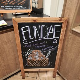 a chalk board with a sign that says fundraiser a chalk board with a sign that says fundraiser