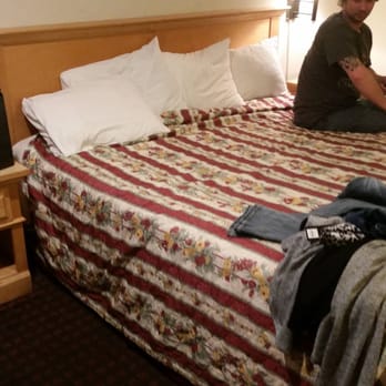Hollister Inn - My husband sitting on the bed to show that the other side is broken down and bowed. Even with him on it, the other side is further down!!! - Hotels Near Me - Hollister, California Hollister Inn - My husband sitting on the bed to show that the other side is broken down and bowed. Even with him on it, the other side is further down!!! - Hotels Near Me - Hollister, California