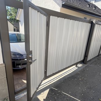 ProHands Handyman - Alley side of gate and fence, with pedestrian door partly open. - Handyman Near Me ProHands Handyman - Alley side of gate and fence, with pedestrian door partly open. - Handyman Near Me