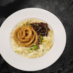 Grille on Main Restaurant & Bar - Chef's Mac Special Maple whiskey infused, white cheddar mac n cheese, BBQ pulled pork, bacon jam and onion rings
