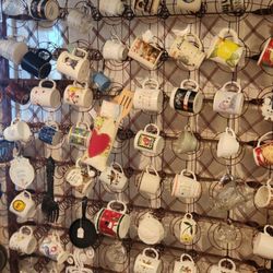 Elegant Junk - Vintage bedspring display of coffee mugs.